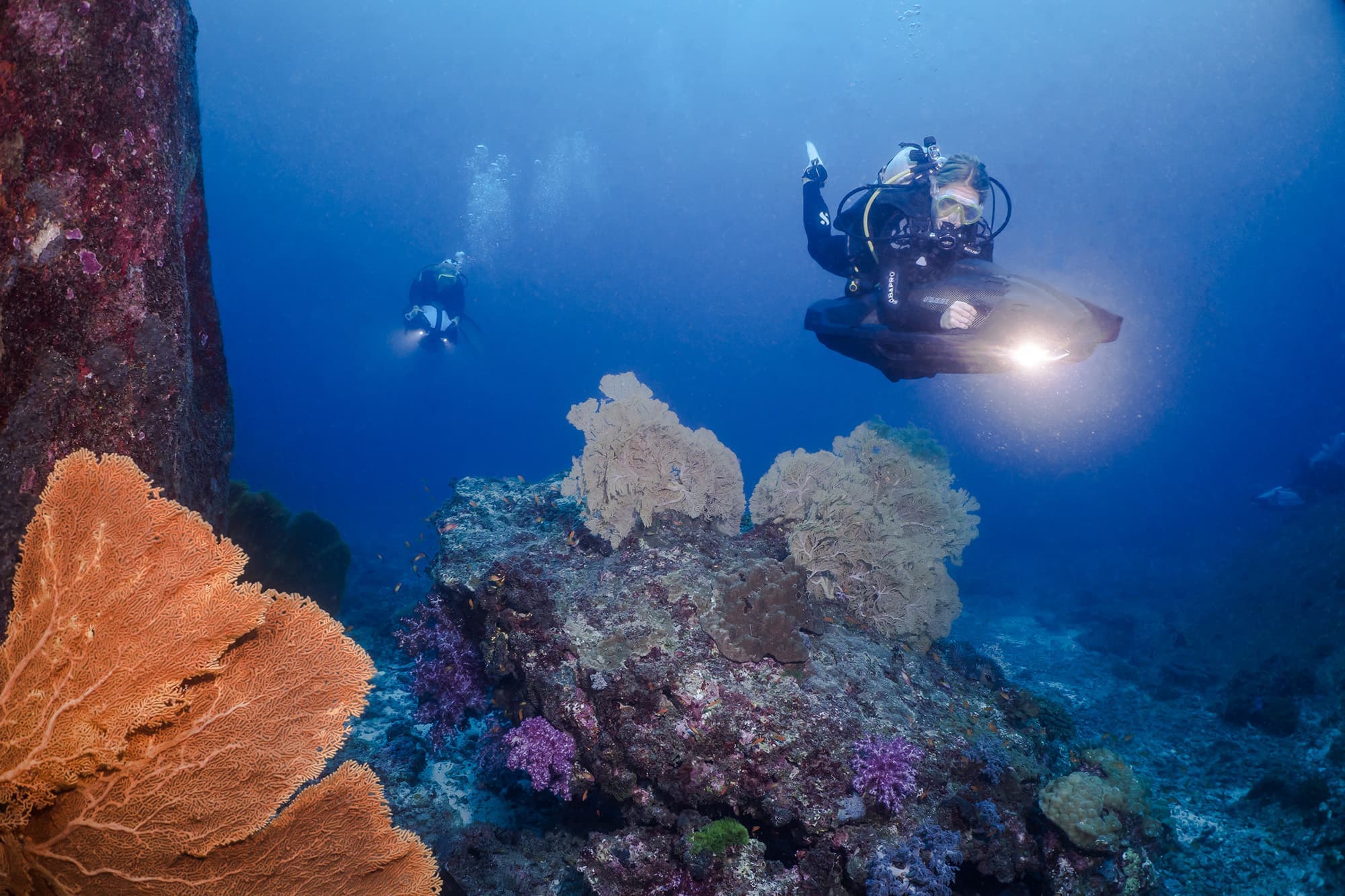 水肺潜水员带着水上玩具探索大海。